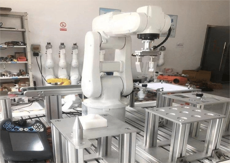 Industrial robotic arm in a manufacturing setup.