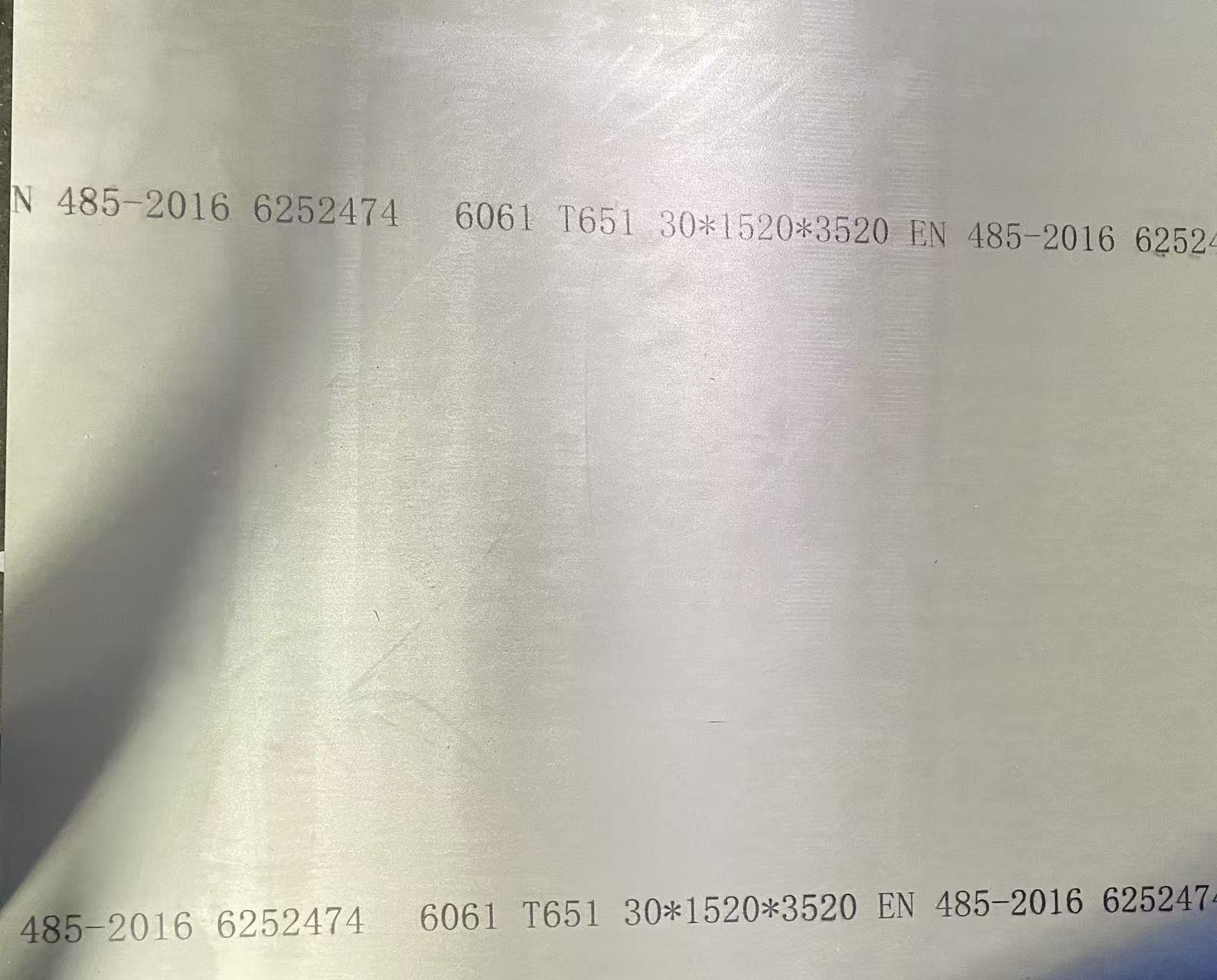 Aluminum sheet with printed technical specifications.