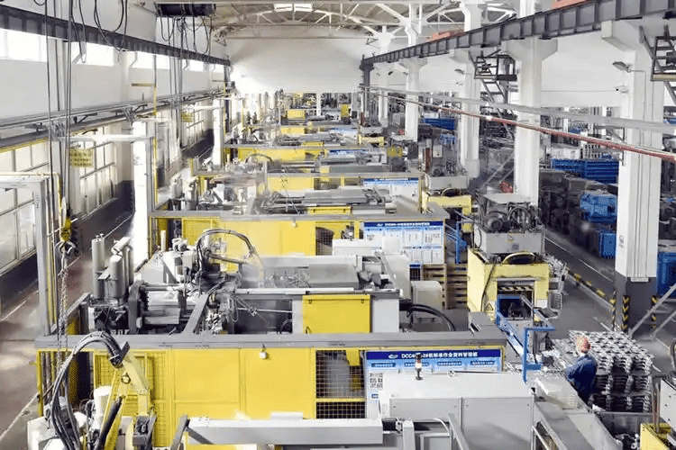 Industrial factory with yellow machinery and workers